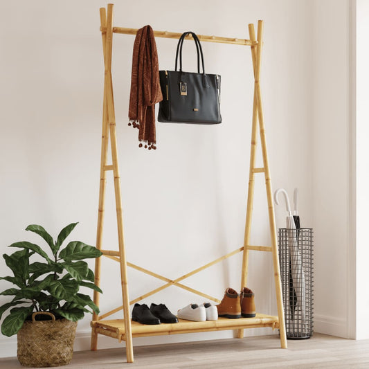Wooden coat rack with shoes, a bag, and an umbrella against a white wall.