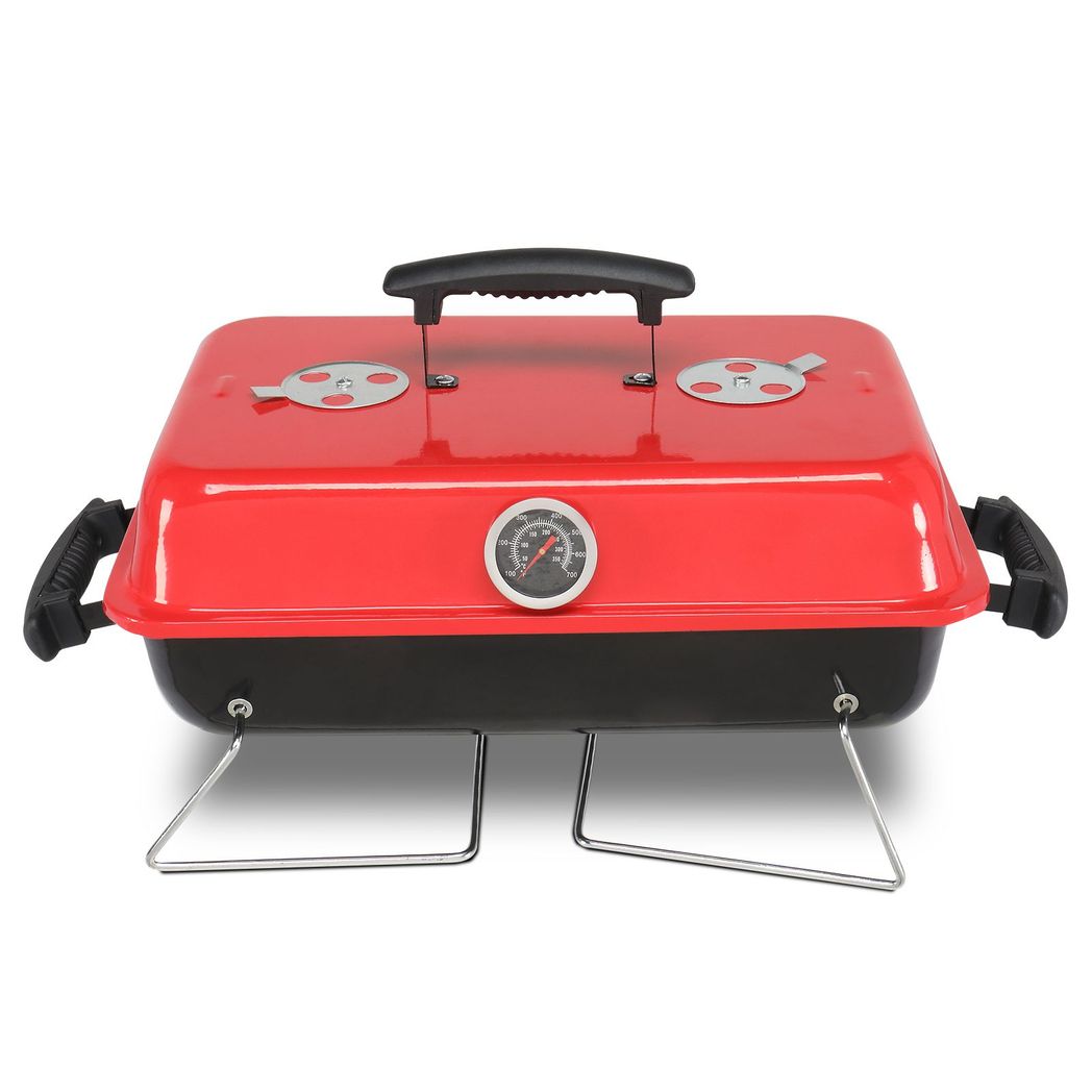 Red portable grill with a black handle on a white background