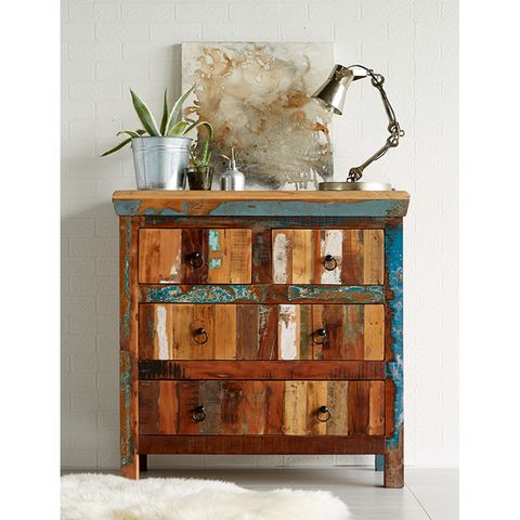 Wooden dresser with distressed finish in a room setting