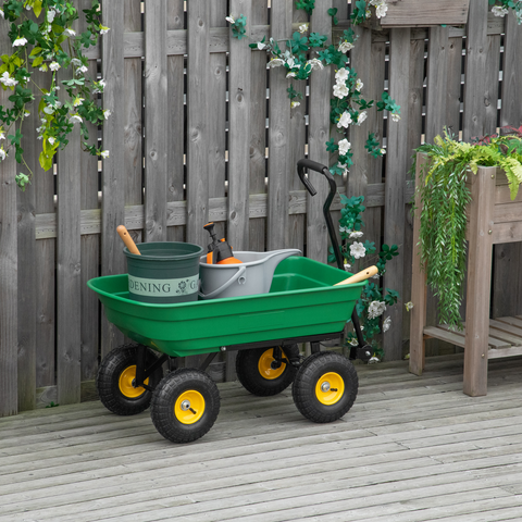 Green garden cart with gardening tools on a wooden deck