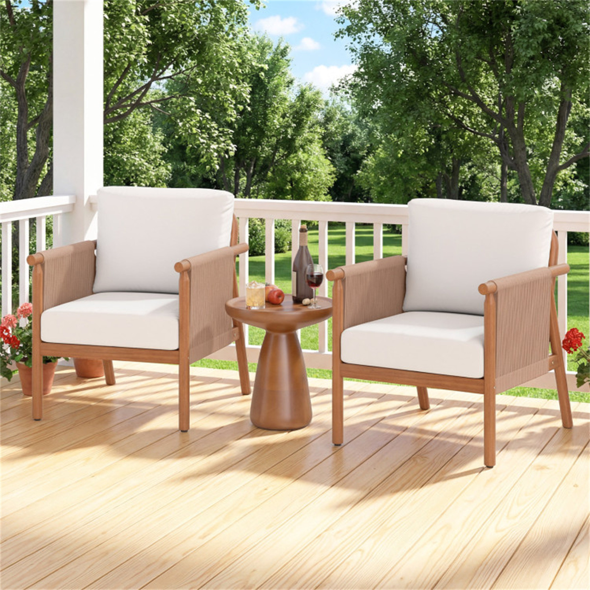Two wooden chairs with white cushions on a wooden deck with a small table, surrounded by greenery.
