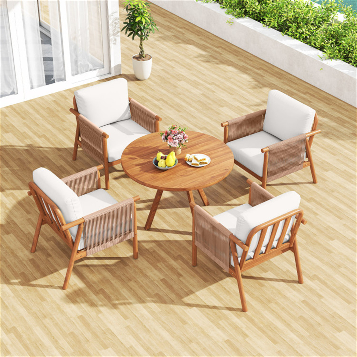 Outdoor furniture set with wooden chairs and table on a deck