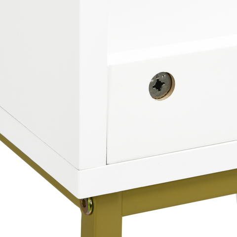Close-up of a white cabinet with a gold leg and lock on a white background
