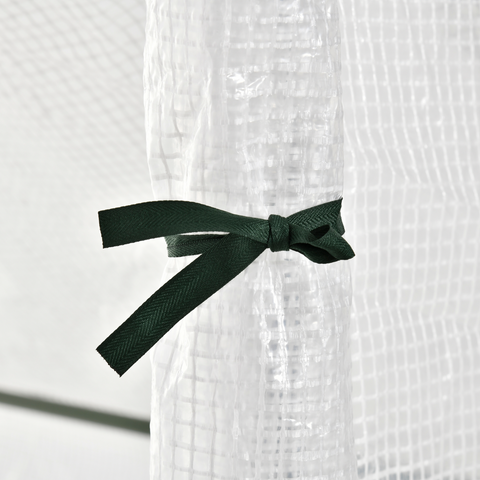 White textured fabric with a green ribbon tied in a bow on a white background