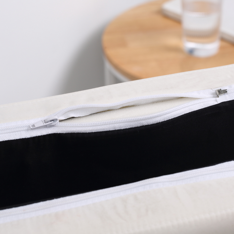 Close-up of a mattress with a zipper, showing the interior layers.